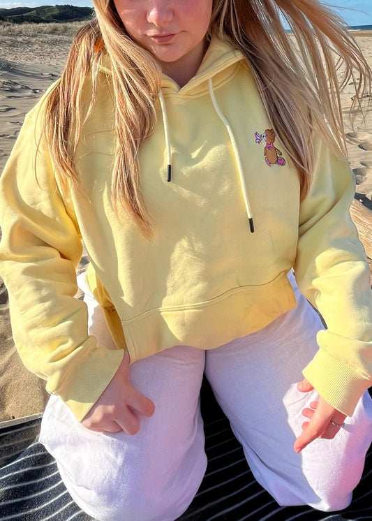 Bright and cheerful Flower Yellow hoodie from BabyBearCollection, ideal for adding a pop of color to any casual outfit. Features include a front pocket and drawstring hood.